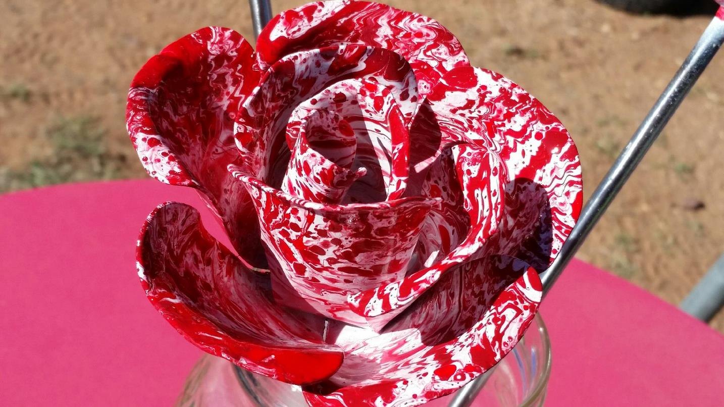 Hand-formed metal rose finished in marbled red and white
